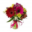 Gerberas and astromeliads arrangement in glass vase